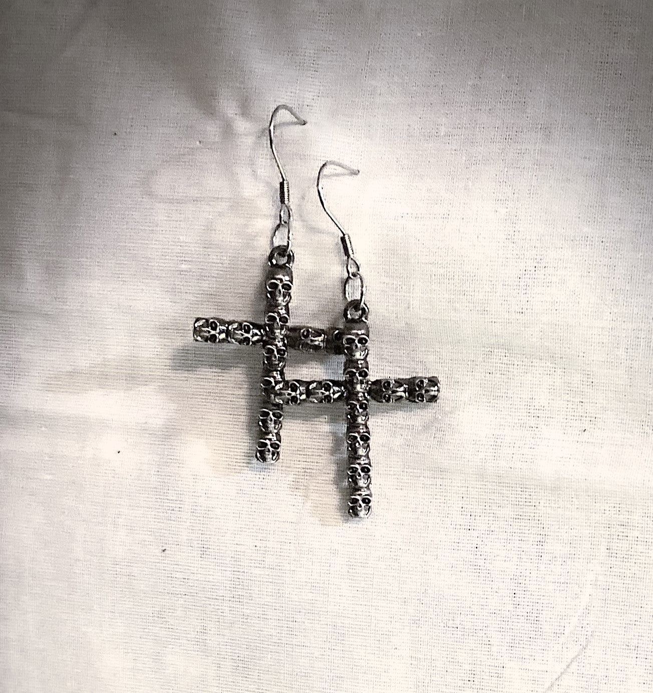 Crucifix In Skulls Earring